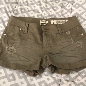 Girls olive green distressed shorts.